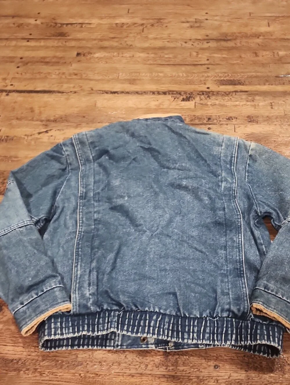 Vtg blue denim bomber jacket featuring a distinctive brown color